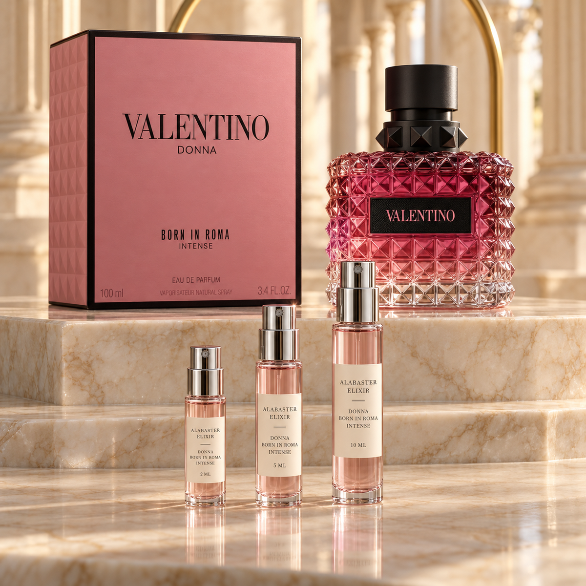 Valentino Donna Born in Roma Intense bottle and box with Alabaster Elixir 2 ml, 5 ml and 10 ml decant atomizers on a marble display.