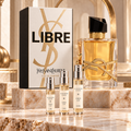 Yves Saint Laurent Libre Eau de Parfum bottle and box with Alabaster Elixir 2 ml, 5 ml and 10 ml decant atomizers on a marble display.