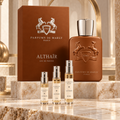 Parfums de Marly Althaïr bottle and box with Alabaster Elixir 2 ml, 5 ml and 10 ml decant atomizers on a marble display.